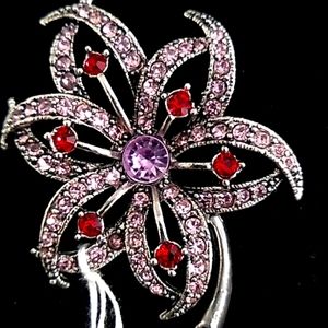 Oggie design  brooch flower with Ruby type stones,light pink and purple center